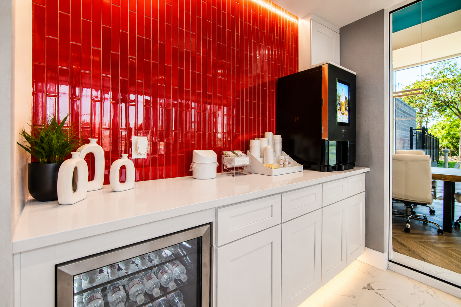 Modern Storage® Bryant coffee bar with red tile accent wall, white cabinets, beverage cooler, and coffee station